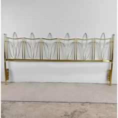 a gold metal bed frame with glass panels