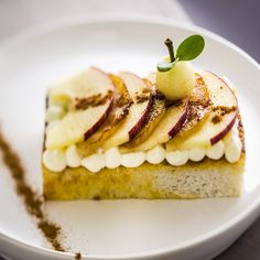 a piece of cake with bananas and other toppings on it sitting on a white plate