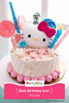 a hello kitty birthday cake with pink and blue decorations