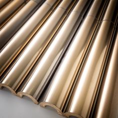 an assortment of metal pipes lined up on a table