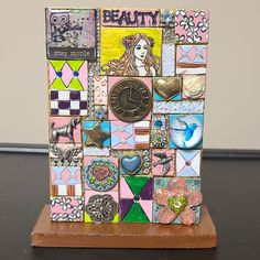 there is a clock made out of many different pieces of art on the table top