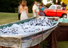 an old boat is filled with ice and people are looking at it in the background