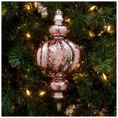 a pink ornament hanging from a christmas tree