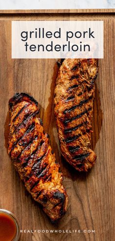 grilled pork tenderion on a cutting board next to a bowl of bbq sauce