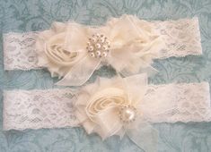 two garters with flowers and pearls on them