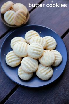 a blue plate topped with cookies on top of a wooden table