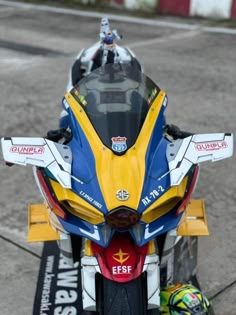 a yellow and blue motorcycle parked on the street