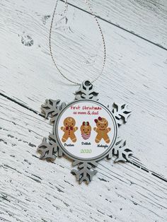 a snowflake ornament with three gingerbread men and women on it