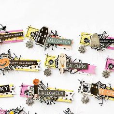 halloween themed paper cutouts are arranged on a white surface with black and orange accents