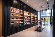 the inside of a shoe store with shelves filled with shoes