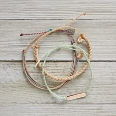 This Set From Pura Vida Comes With Three Bracelets; A Mint String Bracelet With A Rose Gold Bar, A Thick Cream Braided Bracelet + Multi-Colored Original String Bracelet. Nwot: The Item Is In Perfect Condition - 100% Waterproof - Wax Coated - Adjustable From 2-5 Inches In Diameter Please Reach Out With Any Questions On This Item! . Bundle + Save! Enjoy 15% Off When You Purchase Two Or More Items From My Closet Bohemian | Festival | Concert | Spring Break | Summer | Beach | Vacation | Mountains | Sun | Surf | Swim | Water | Summertime | Athleisure | Yoga Bracelet Pura Vida, Pura Vida Bracelets Stacked, Summertime Athleisure, Pura Vida Bracelets Aesthetic, Puravida Bracelets, Vacation Mountains