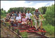 a group of people riding on the back of an old fashioned roller coaster down train tracks