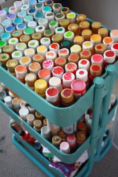 a cart filled with lots of different colored paints