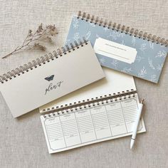 three calendars and a pen on a table