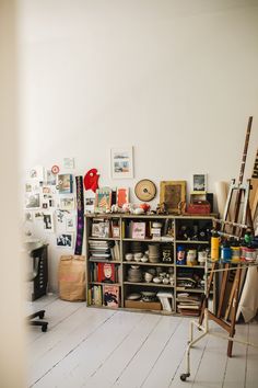 a room filled with lots of clutter and art supplies