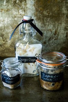 three jars filled with food sitting on top of a table