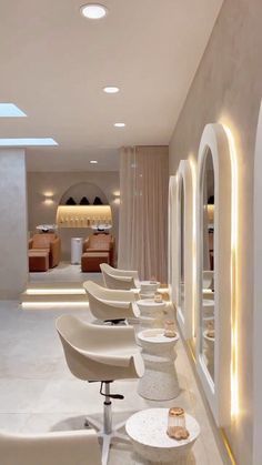 a row of white chairs sitting next to each other in front of a counter top