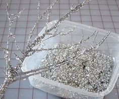 a plastic container filled with sparkling branches