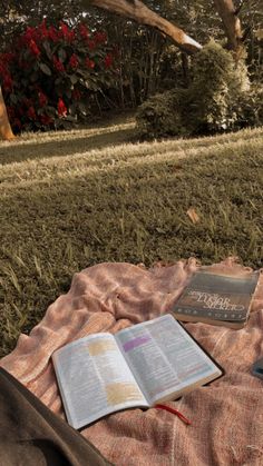 an open book sitting on top of a blanket