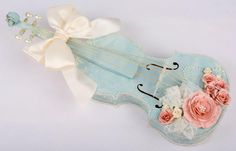 a violin decorated with flowers and pearls