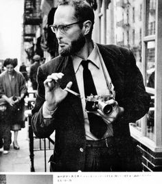 a man holding a camera in his right hand