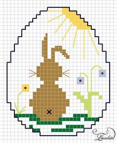 a cross stitch pattern with a bunny sitting in the grass