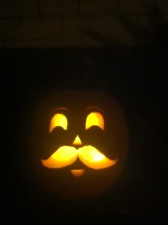 a pumpkin carved to look like a mustache