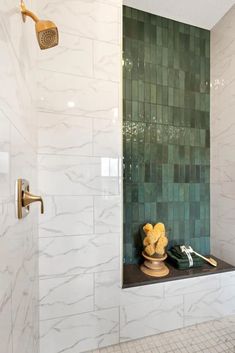 there is a shower with green tile on the wall