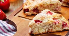 two pieces of strawberry scones on a cutting board