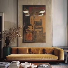 a living room filled with furniture and a painting on the wall