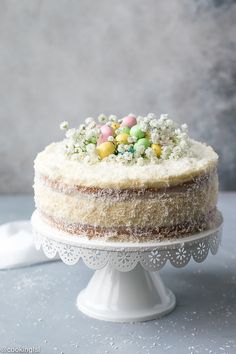 a cake with white frosting and colorful candies on top