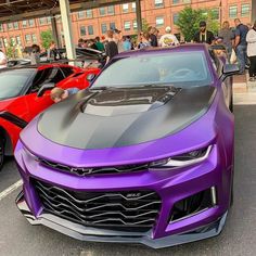 some very nice looking cars in a parking lot