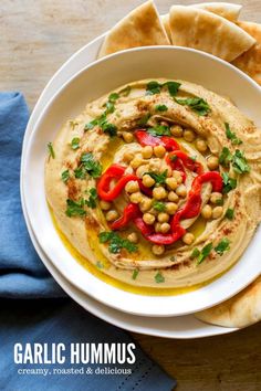 hummus and pita bread on a white plate