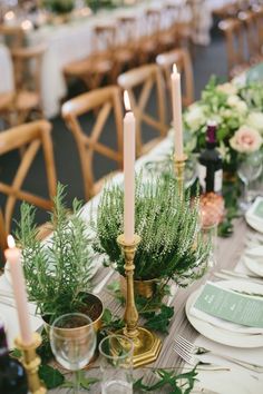 the table is set with candles and place settings