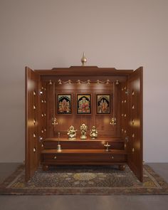 a wooden shrine with three buddhas on it