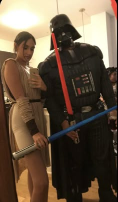 two people dressed up as darth vader and stormtrooper are standing next to each other