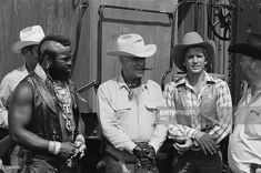 three men in cowboy hats standing next to each other