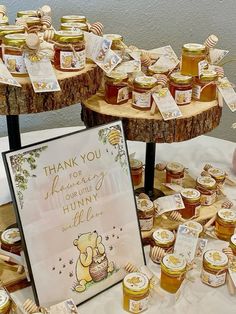 there are many honey jars on the table with thank you cards and tags around them