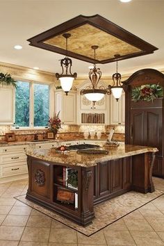 a large kitchen with marble counter tops and an island in front of the stove top