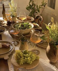 the table is set with plates, wine glasses and other items for dinner or brunch