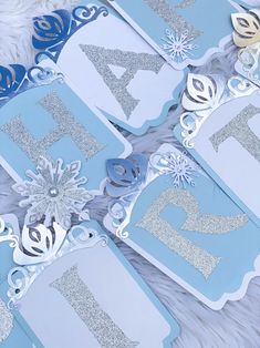 blue and silver snowflaked birthday decorations with the number twenty five on them