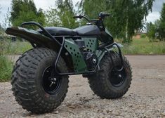 an off - road vehicle is parked on the gravel