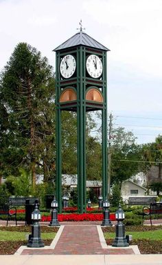 a clock tower in the middle of a park