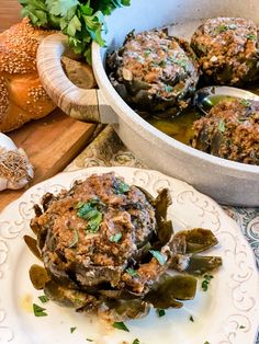 some food is sitting on a plate next to bread and other foods are in the background