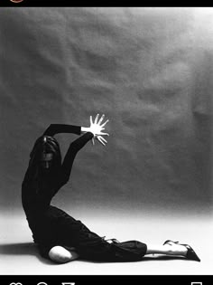 a black and white photo of a woman doing yoga