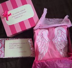 a pink box with an angel design on it and a note in the bottom right corner