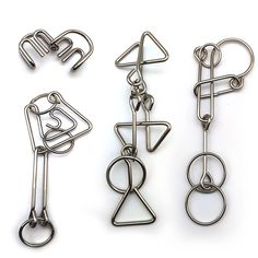 three metal clips with different shapes and sizes on white background, one has an eye