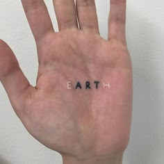 a hand with the word earth written on it