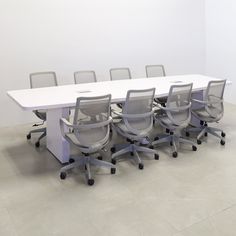 a long table with six chairs around it in an empty room or conference room area