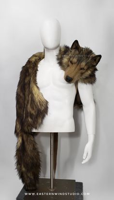 a white mannequin with brown fur on it's head and arms, standing next to a furry animal